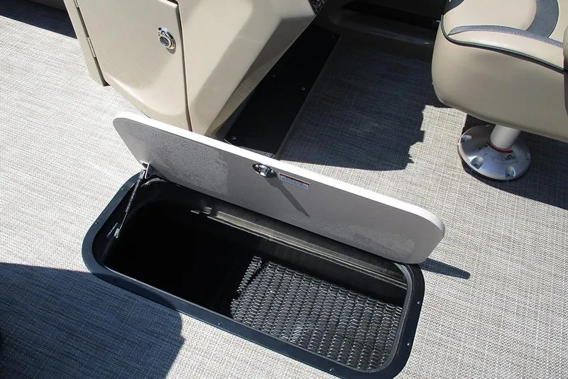 Slide: The Image of 2025 Viaggio Lago X22U boat interior storage compartment with open hatch on carpeted floor. - 23