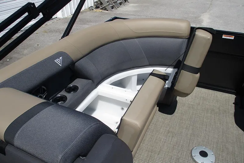Slide: The Image of 2025 Viaggio Lago X22U boat interior with beige and gray seating, cup holders, and carpeted floor. - 26