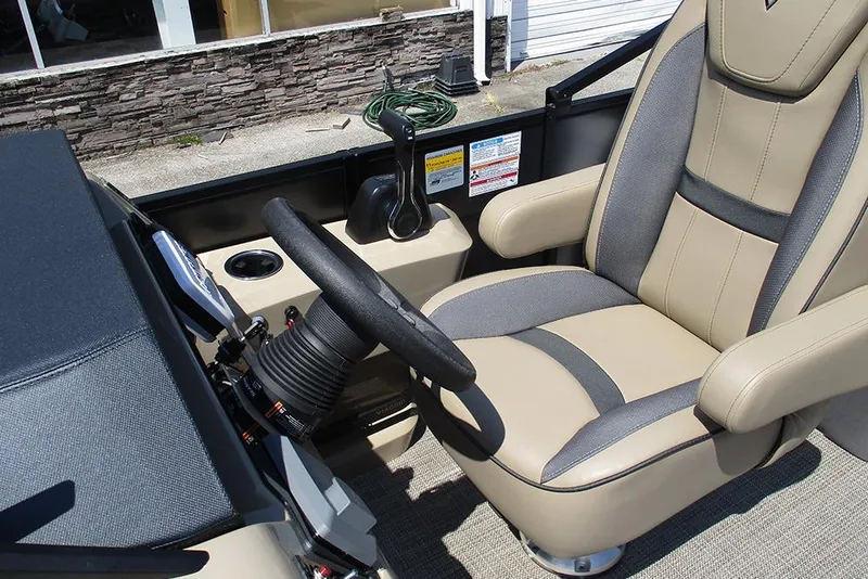 Slide: The Image of Captain's seat and steering of 2025 Viaggio Lago X22U boat, featuring modern controls. - 39