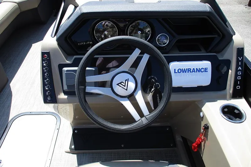 Slide: The Image of 2025 Viaggio Lago X22U boat dashboard with steering wheel and Lowrance navigation system. - 40