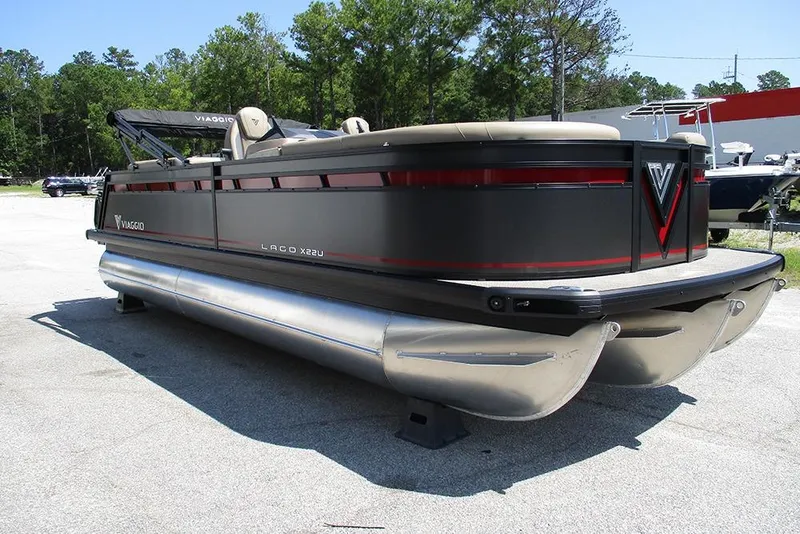 Slide: The Image of 2025 Viaggio Lago X22U pontoon boat with sleek design, parked outdoors. - 5