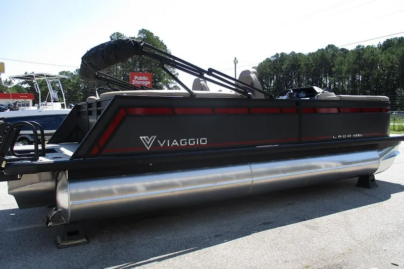 Slide: The Image of 2025 Viaggio Lago X22U pontoon boat parked outdoors, featuring sleek design and modern amenities. - 6