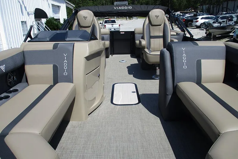 Slide: The Image of 2025 Viaggio Lago X22U pontoon boat interior with beige and gray seating. - 9