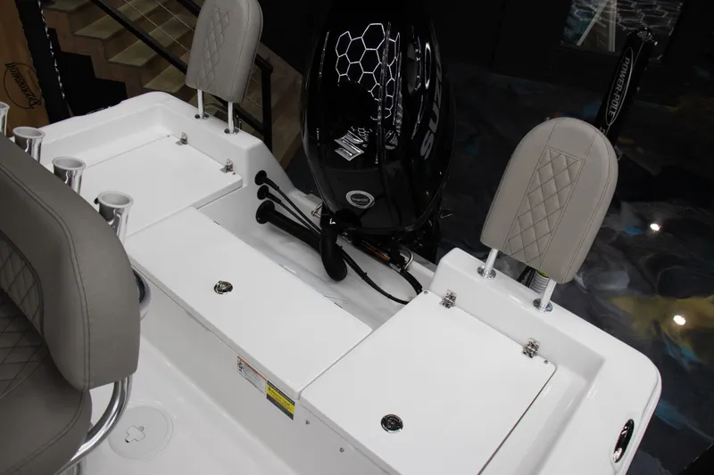 Slide: The Image of 2025 Savannah 210X boat interior with cushioned seats and motor detail. - 10