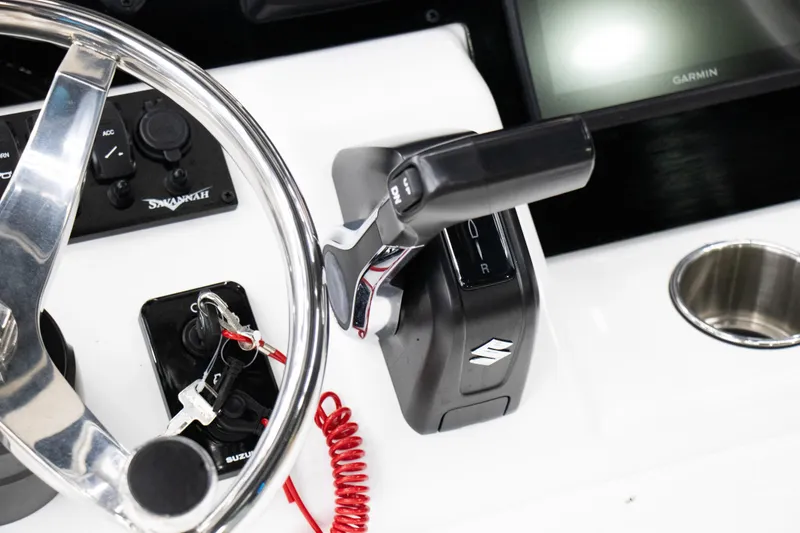 Slide: The Image of 2025 Savannah 210X boat dashboard with steering wheel and controls. - 12