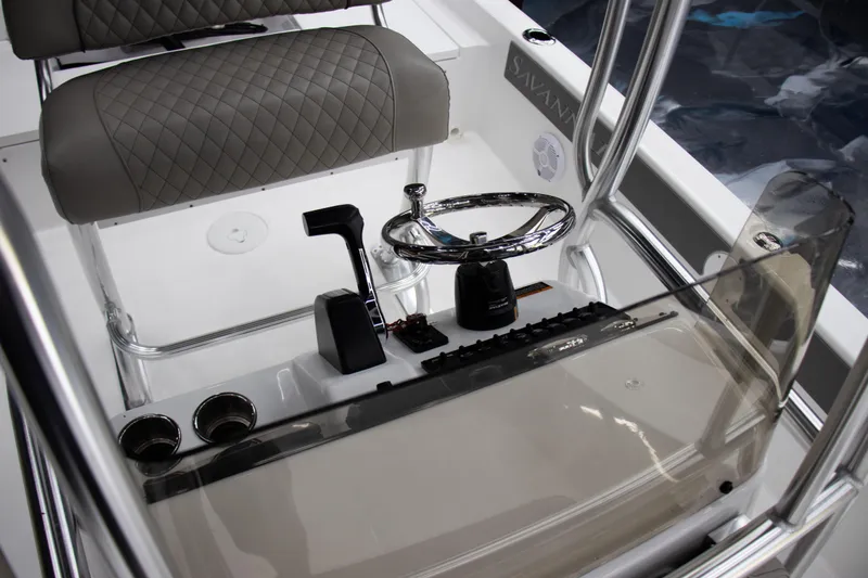 Slide: The Image of 2025 Savannah 210X boat console with steering wheel and controls, featuring modern design elements. - 14