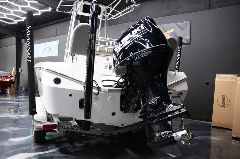 Slide: The Image of 2025 Savannah 210X boat with Suzuki outboard motor in showroom. - 17