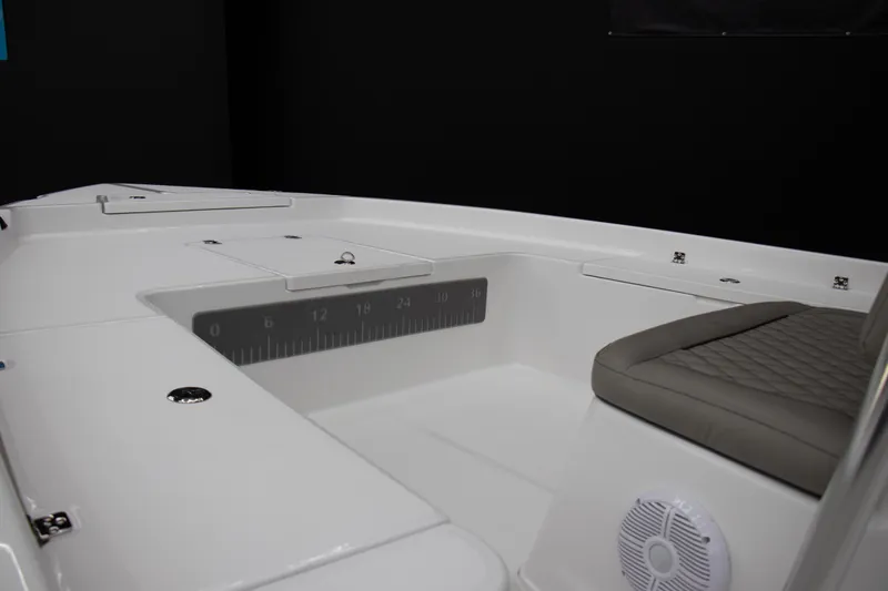 Slide: The Image of 2025 Savannah 210X boat interior with seating, storage compartments, and ruler markings. - 5