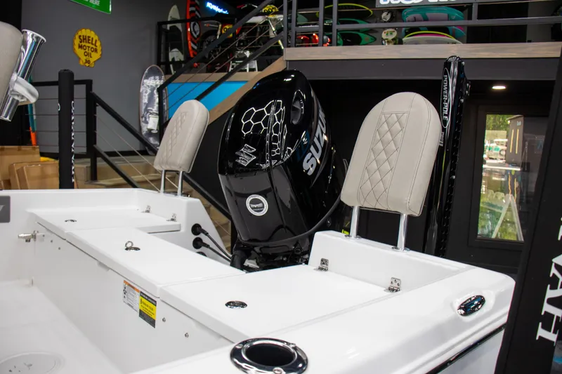 Slide: The Image of 2025 Savannah 210X boat interior with Suzuki outboard motor and cushioned seats. - 7
