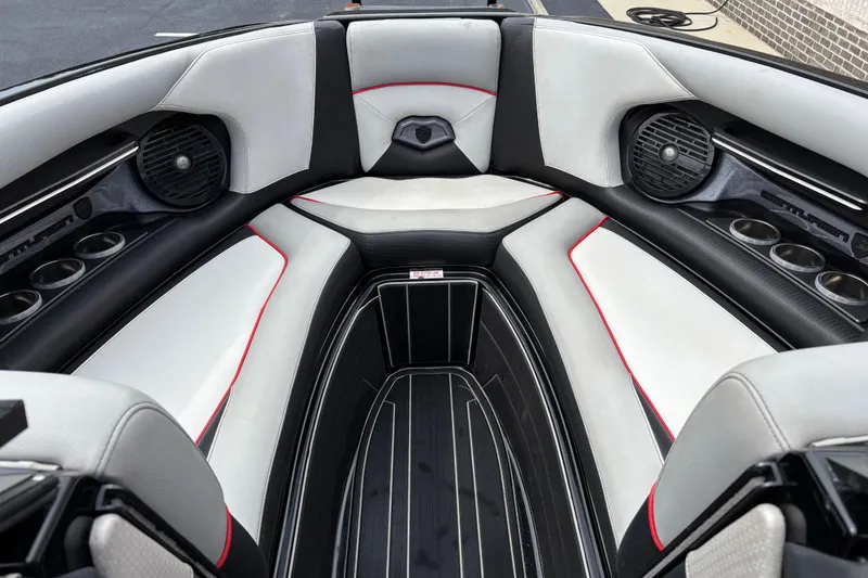 Slide: The Image of 2018 Centurion Ri257 boat interior with sleek seating, cup holders, and speakers. - 7