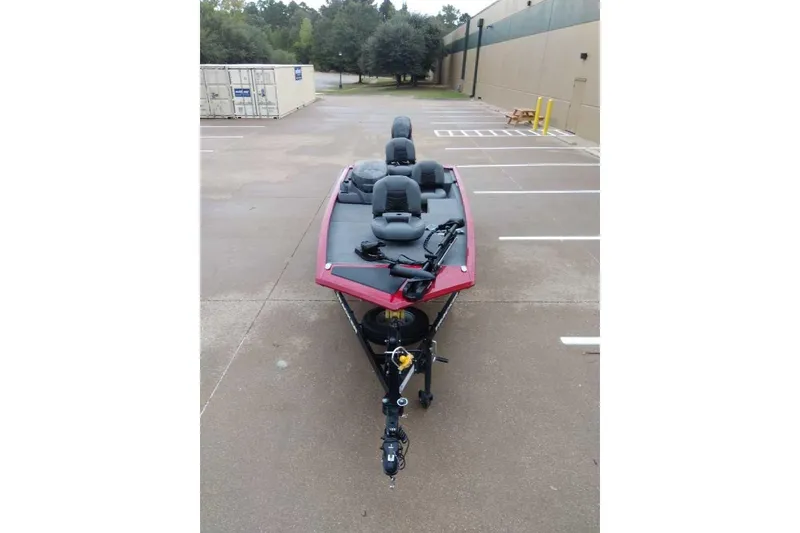 Slide: The Image of 2024 Bass Tracker Pro 170 boat parked in an empty lot, featuring a sleek red design. - 10