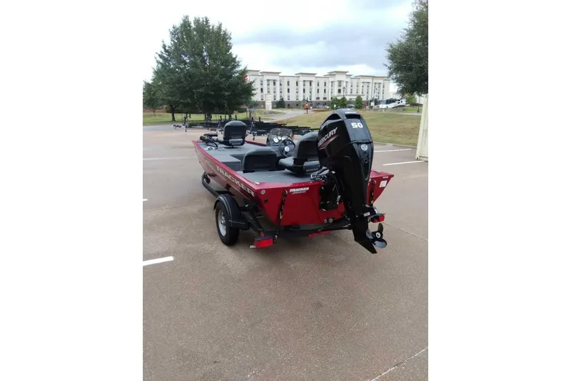 Slide: The Image of 2024 Bass Tracker Pro 170 boat with Mercury engine in a parking lot. - 3