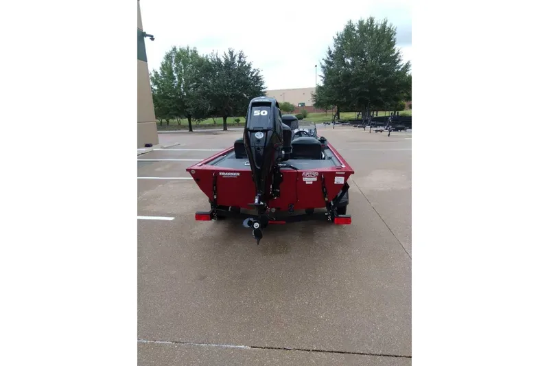 Slide: The Image of 2024 Bass Tracker Pro 170 boat, red, parked outdoors, rear view with motor. - 5
