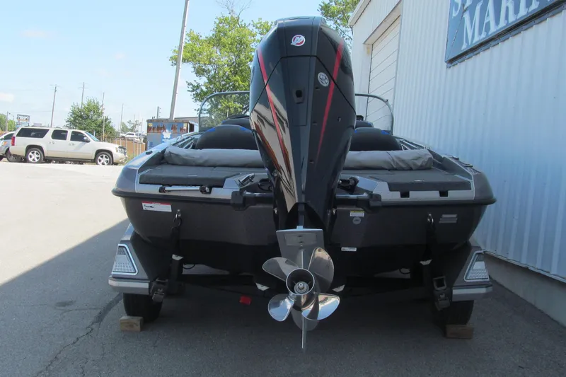 Slide: The Image of 2026 Ranger 212LS boat with powerful outboard motor, parked outdoors. - 4