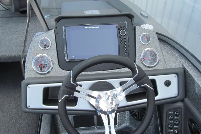 Slide: The Image of 2026 Ranger 212LS boat dashboard with steering wheel and electronic display. - 7