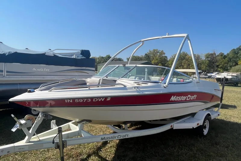 The Image of 1996 MasterCraft MariStar 210 VRS boat on trailer, parked outdoors. - 0