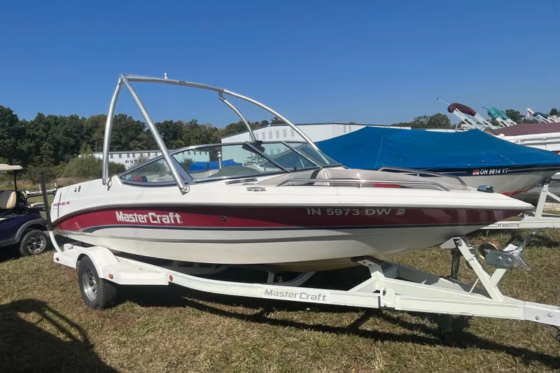 Slide: The Image of 1996 MasterCraft MariStar 210 VRS boat on trailer, parked outdoors. - 1