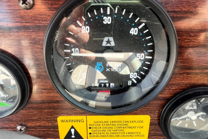 Slide: The Image of 1996 MasterCraft MariStar 210 VRS dashboard with RPM gauge and warning label. - 13