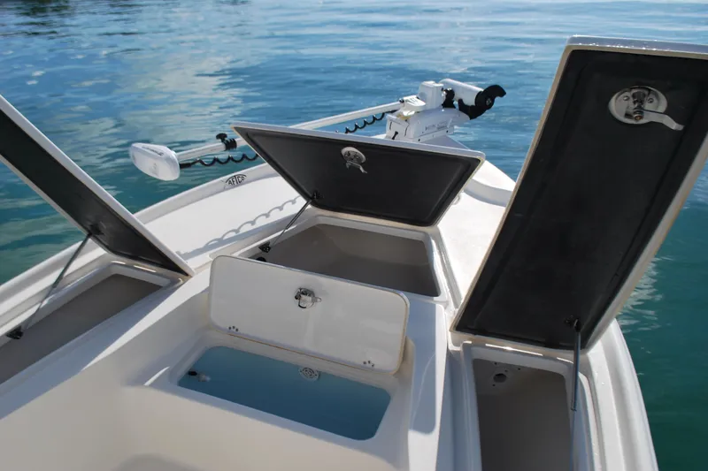 Slide: The Image of 2021 Key West 210 Bay Reef boat with open storage compartments on calm water. - 8