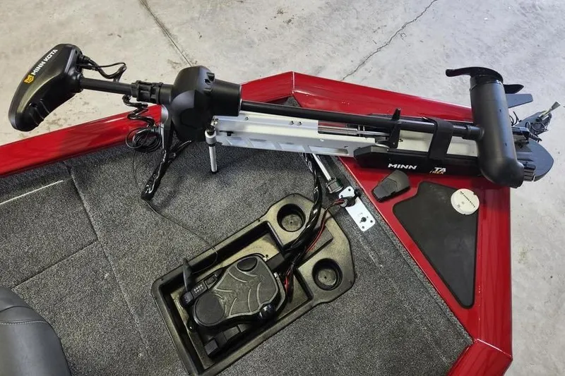 Slide: The Image of 2025 Tracker Pro Team 175 boat with Minn Kota trolling motor on red deck. - 7