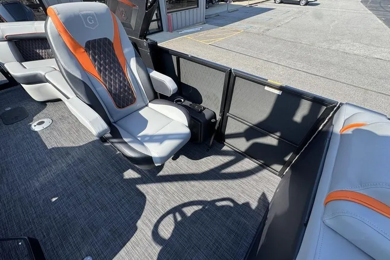 Slide: The Image of Captain's chair on 2026 Godfrey XP 2700 TWIN boat, featuring sleek design and orange accents. - 16