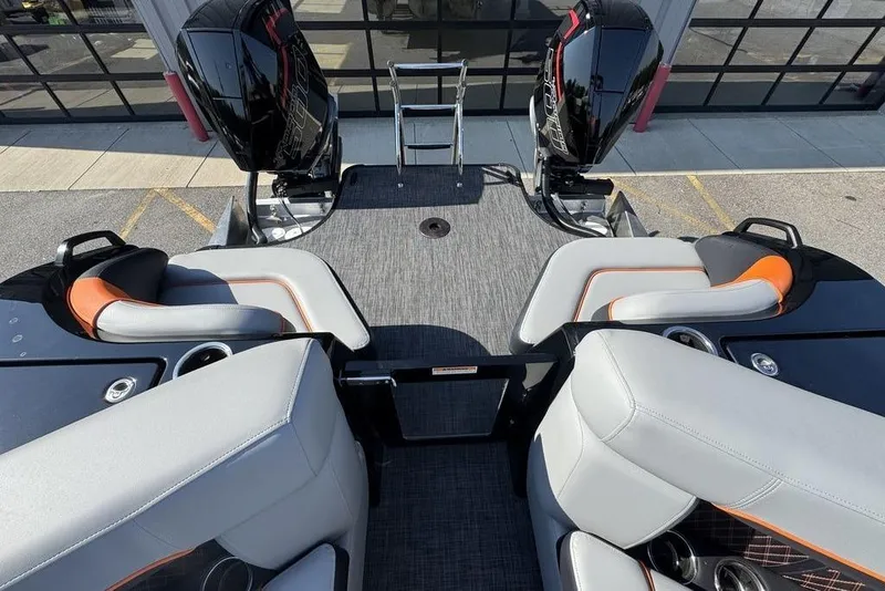 Slide: The Image of 2026 Godfrey XP 2700 TWIN boat interior with dual engines and modern seating. - 19