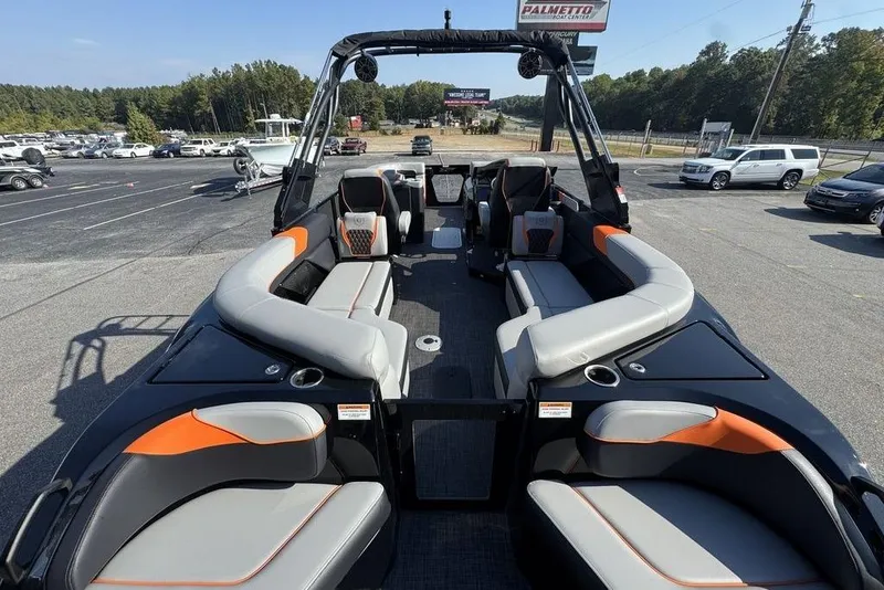 Slide: The Image of 2026 Godfrey XP 2700 TWIN boat with spacious seating and modern design in a parking lot. - 23