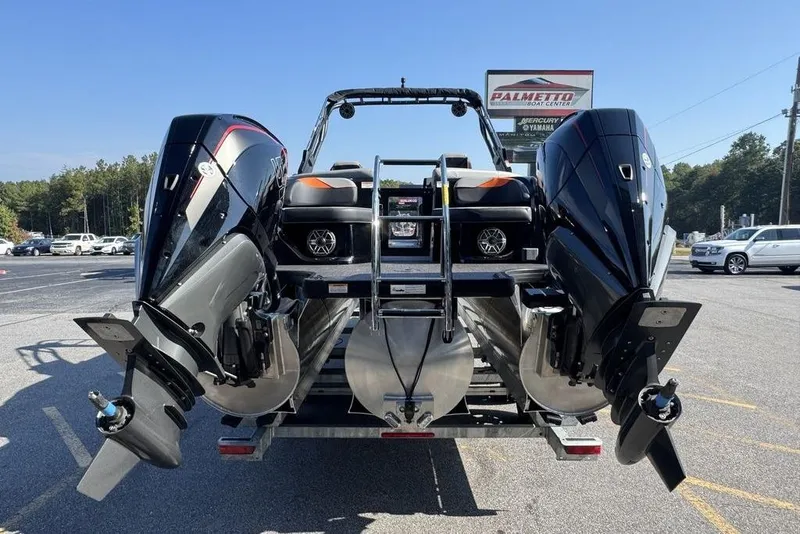 Slide: The Image of 2026 Godfrey XP 2700 TWIN boat with dual outboard motors, parked outdoors. - 3