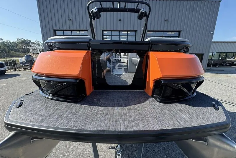 Slide: The Image of 2026 Godfrey XP 2700 TWIN boat with orange accents, displayed outdoors. - 7