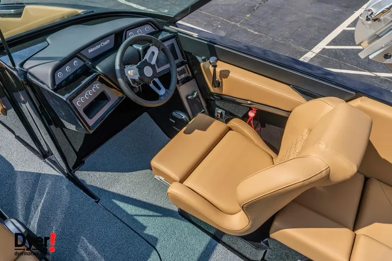 Slide: The Image of 2026 MasterCraft NXT22 boat interior with tan leather seats and modern dashboard. - 11