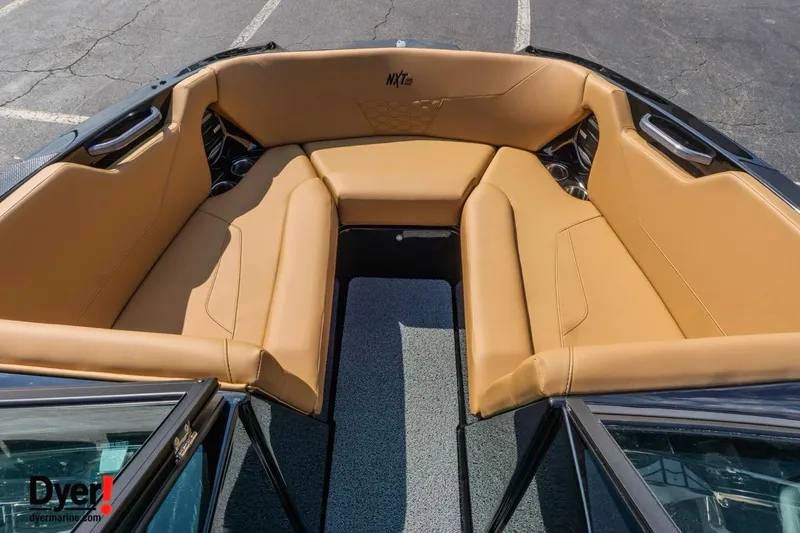 Slide: The Image of 2026 MasterCraft NXT22 boat interior with tan seating and modern design. - 12