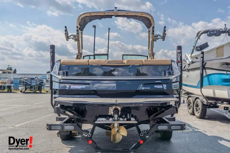 Slide: The Image of 2026 MasterCraft NXT22 boat displayed at Dyer Marine dealership, rear view. - 4
