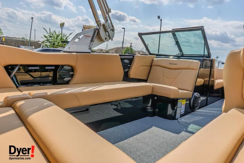 Slide: The Image of 2026 MasterCraft NXT22 boat interior with tan seating and modern design. - 9