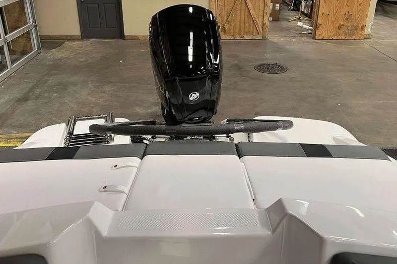 Slide: The Image of 2026 Tahoe T16 boat with a sleek black motor in a garage setting. - 3