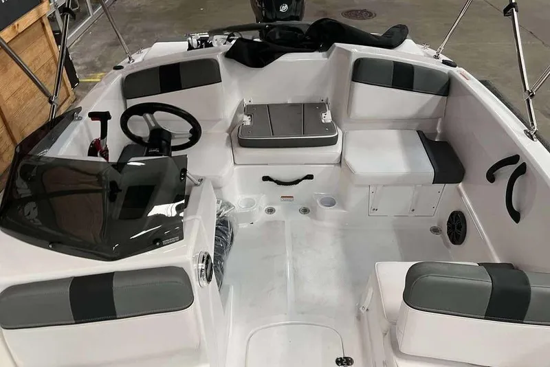 Slide: The Image of 2026 Tahoe T16 boat interior with seating, steering wheel, and storage compartments. - 4