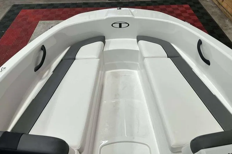 Slide: The Image of 2026 Tahoe T16 boat interior with white and gray seating, black handles, and red checkered floor. - 5