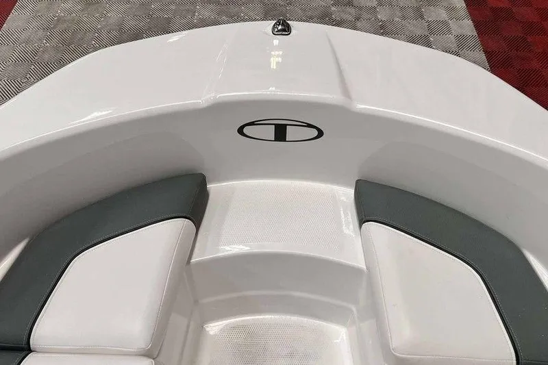 Slide: The Image of 2026 Tahoe T16 boat interior with white and gray seating on patterned flooring. - 7