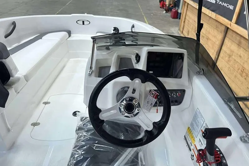 Slide: The Image of 2026 Tahoe T16 boat interior with steering wheel and control panel. - 8
