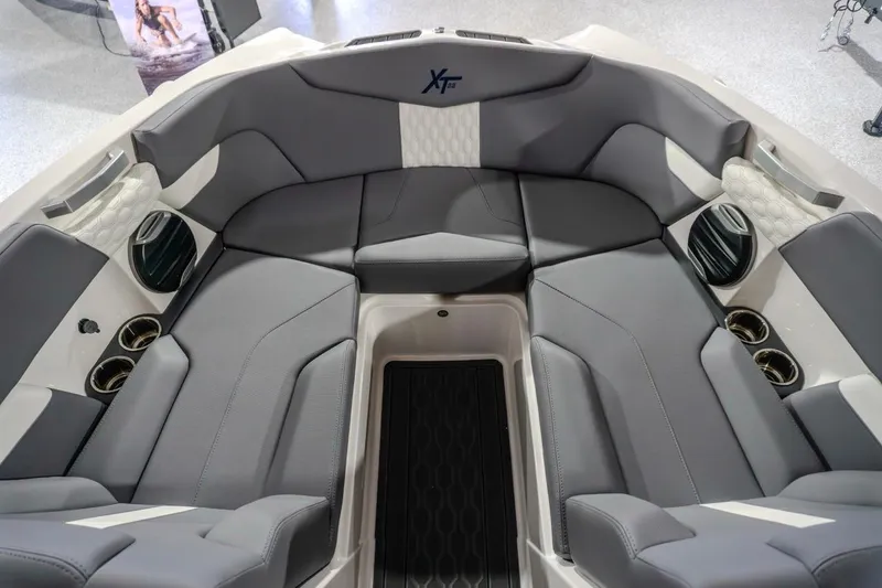 Slide: The Image of 2026 MasterCraft XT22 boat interior with gray seating and cup holders. - 4