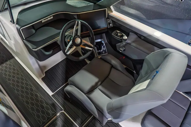 Slide: The Image of 2026 MasterCraft XT22 boat interior with modern steering and dashboard design. - 7
