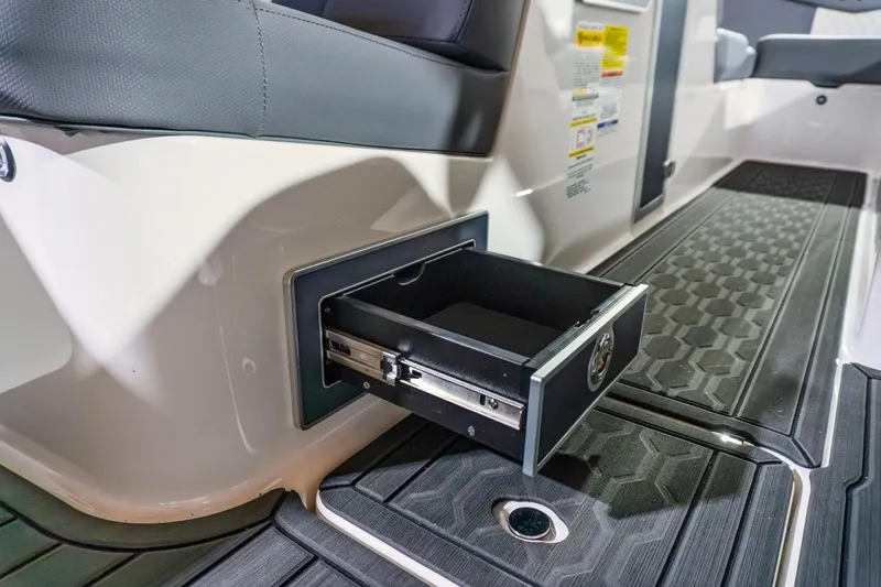 Slide: The Image of 2026 MasterCraft XT22 boat interior with open storage drawer and textured flooring. - 8