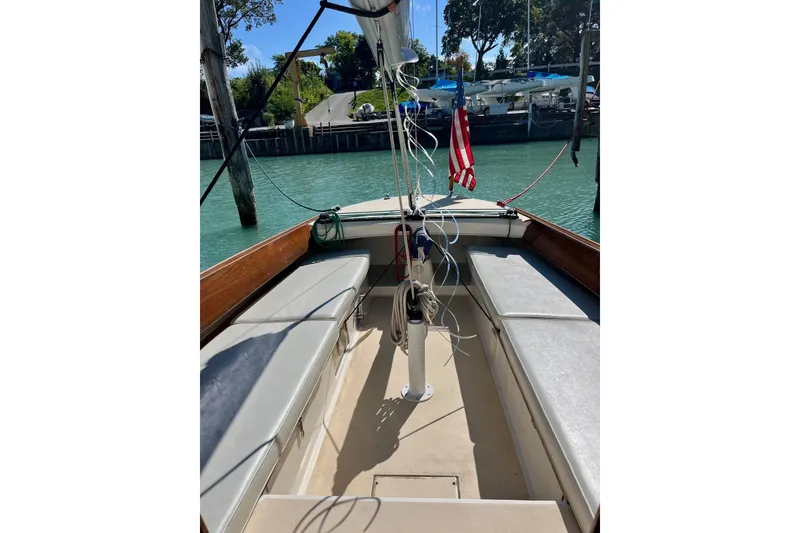 Slide: The Image of 2012 Alerion Express 28 sailboat interior with seating and American flag. - 2