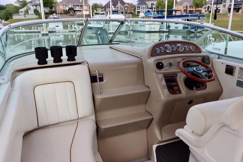 Slide: The Image of 2000 Sea Ray 270 Sundancer boat interior with steering wheel and dashboard controls. - 10