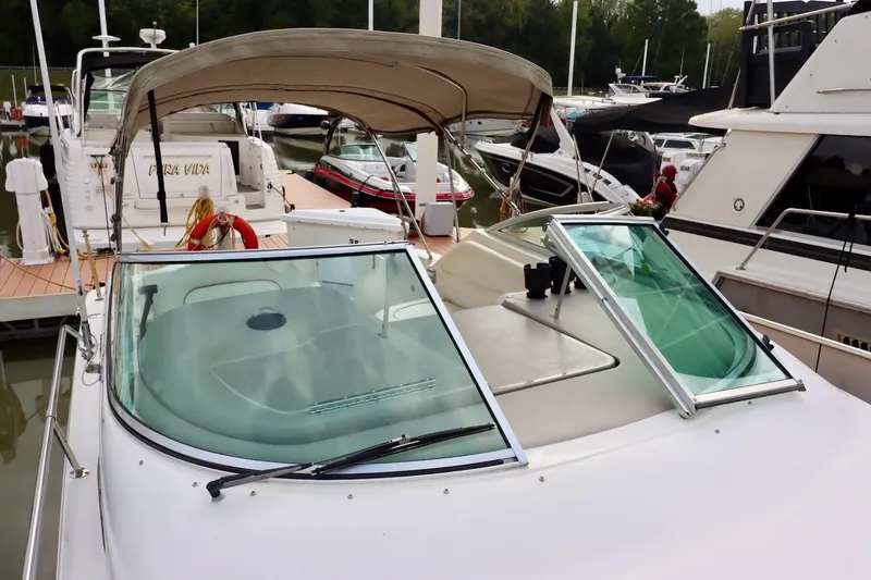 Slide: The Image of 2000 Sea Ray 270 Sundancer docked at marina with canopy and open windshield. - 14