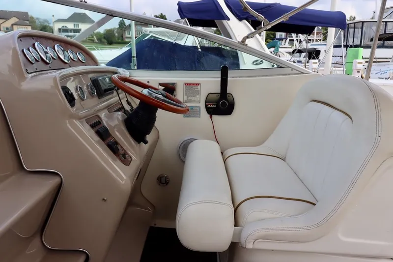 Slide: The Image of Cockpit of 2000 Sea Ray 270 Sundancer with steering wheel and control panel. - 16