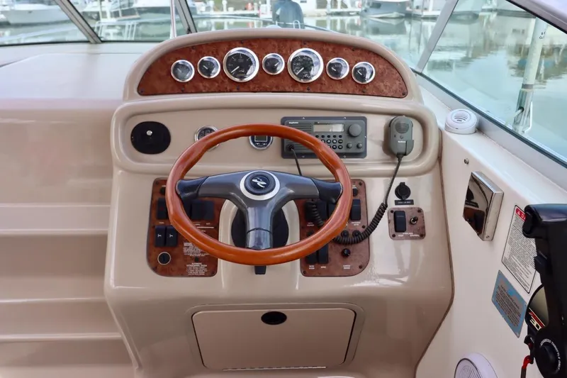 Slide: The Image of Cockpit of 2000 Sea Ray 270 Sundancer with steering wheel and control panel. - 17