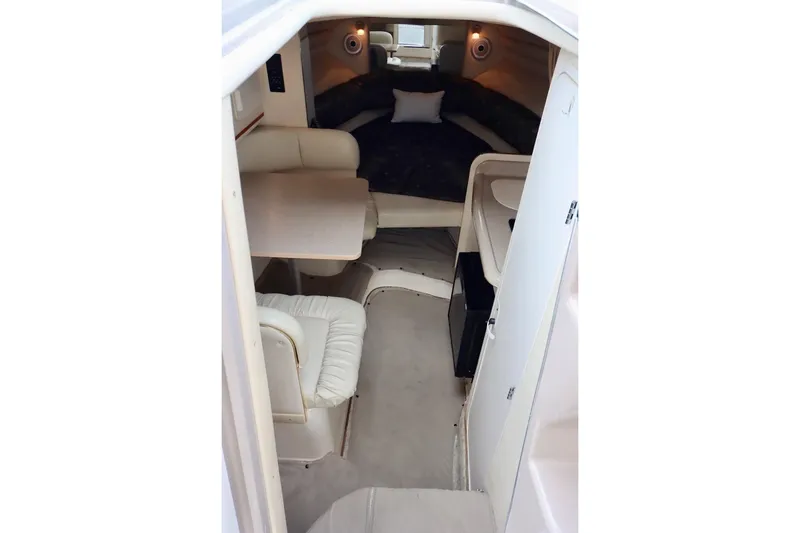 Slide: The Image of Interior of 2000 Sea Ray 270 Sundancer with seating, table, and bed. - 20