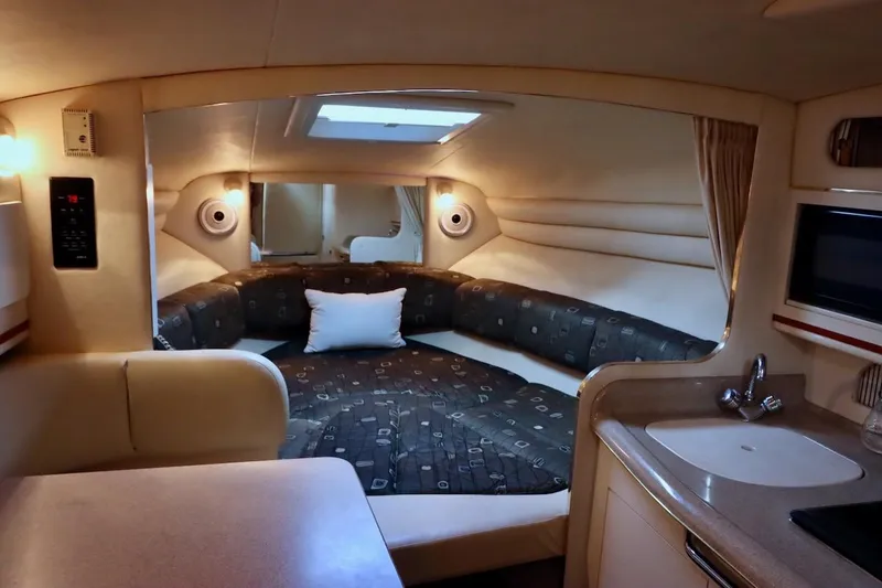 Slide: The Image of Interior of 2000 Sea Ray 270 Sundancer boat with cozy cabin and kitchenette. - 21