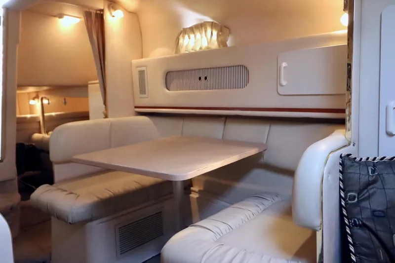 Slide: The Image of Interior of 2000 Sea Ray 270 Sundancer boat with cozy seating and table. - 23