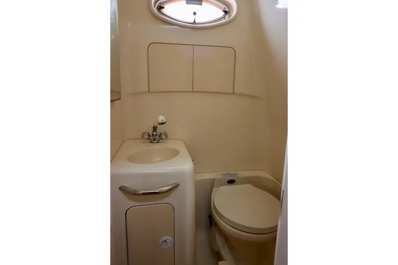 Slide: The Image of Compact bathroom in 2000 Sea Ray 270 Sundancer boat with sink and toilet. - 25